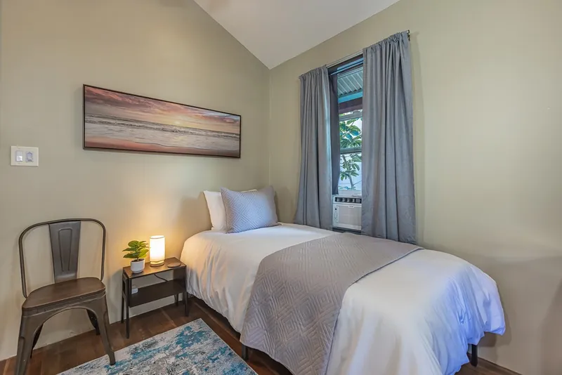 1 of 2 Twin Beds in Guest Room — Historic 2BR Condo, Wailuku